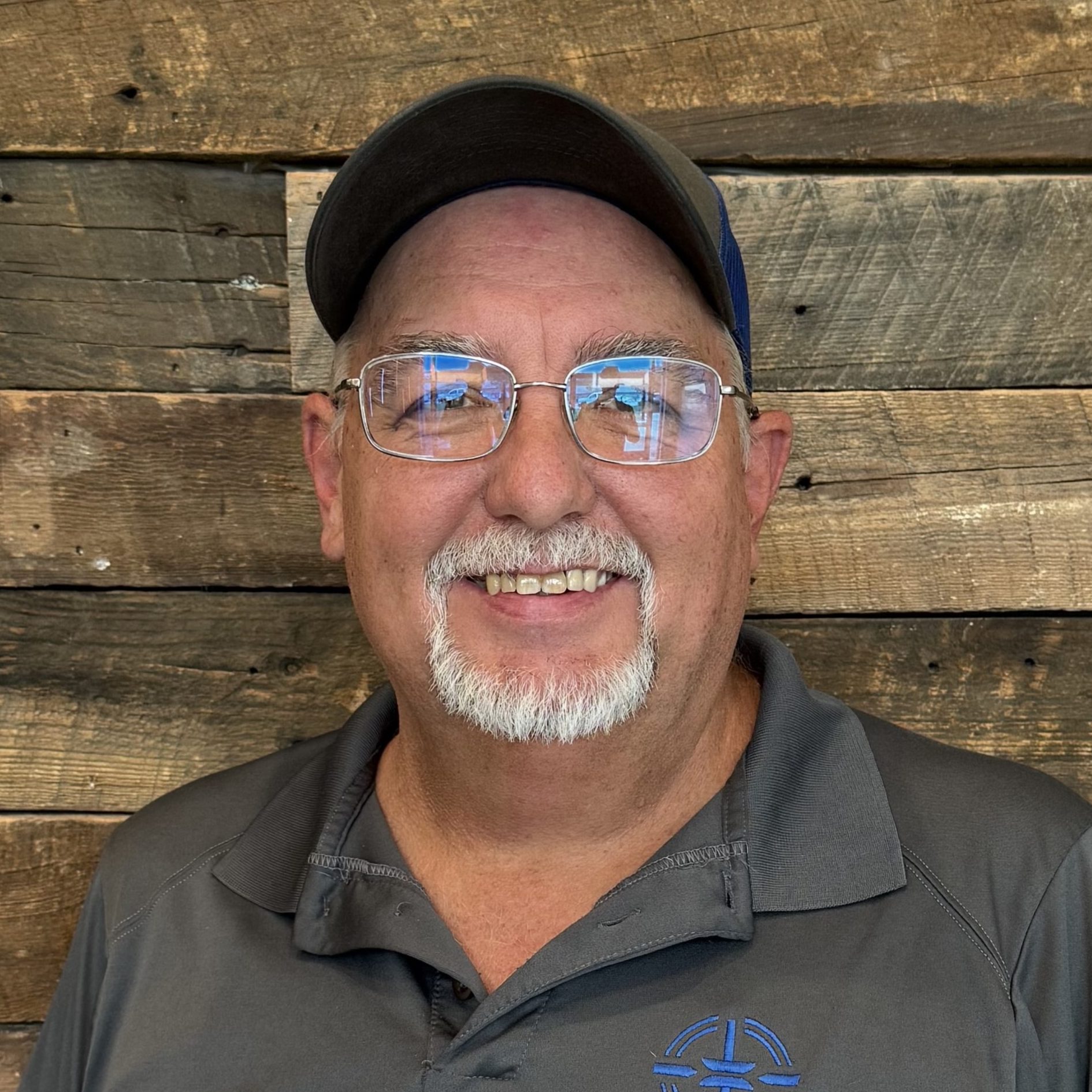 a man wearing glasses and smiling at the camera a man wearing glasses and smiling at the camera